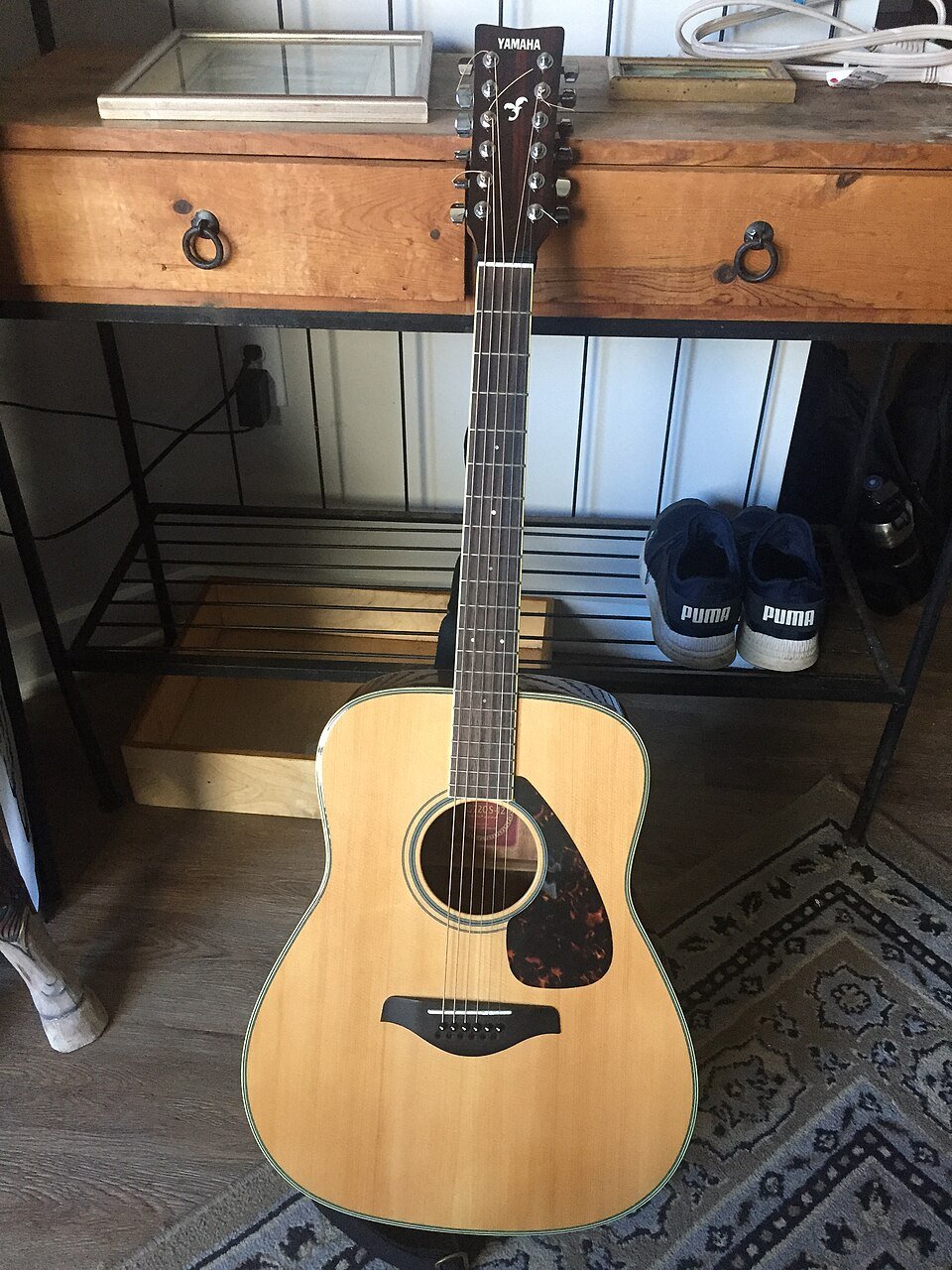 How can someone replace guitar strings?